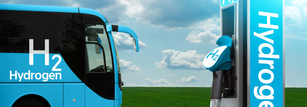 Tank trailer with hydrogen on the background of a green field and blue sky.